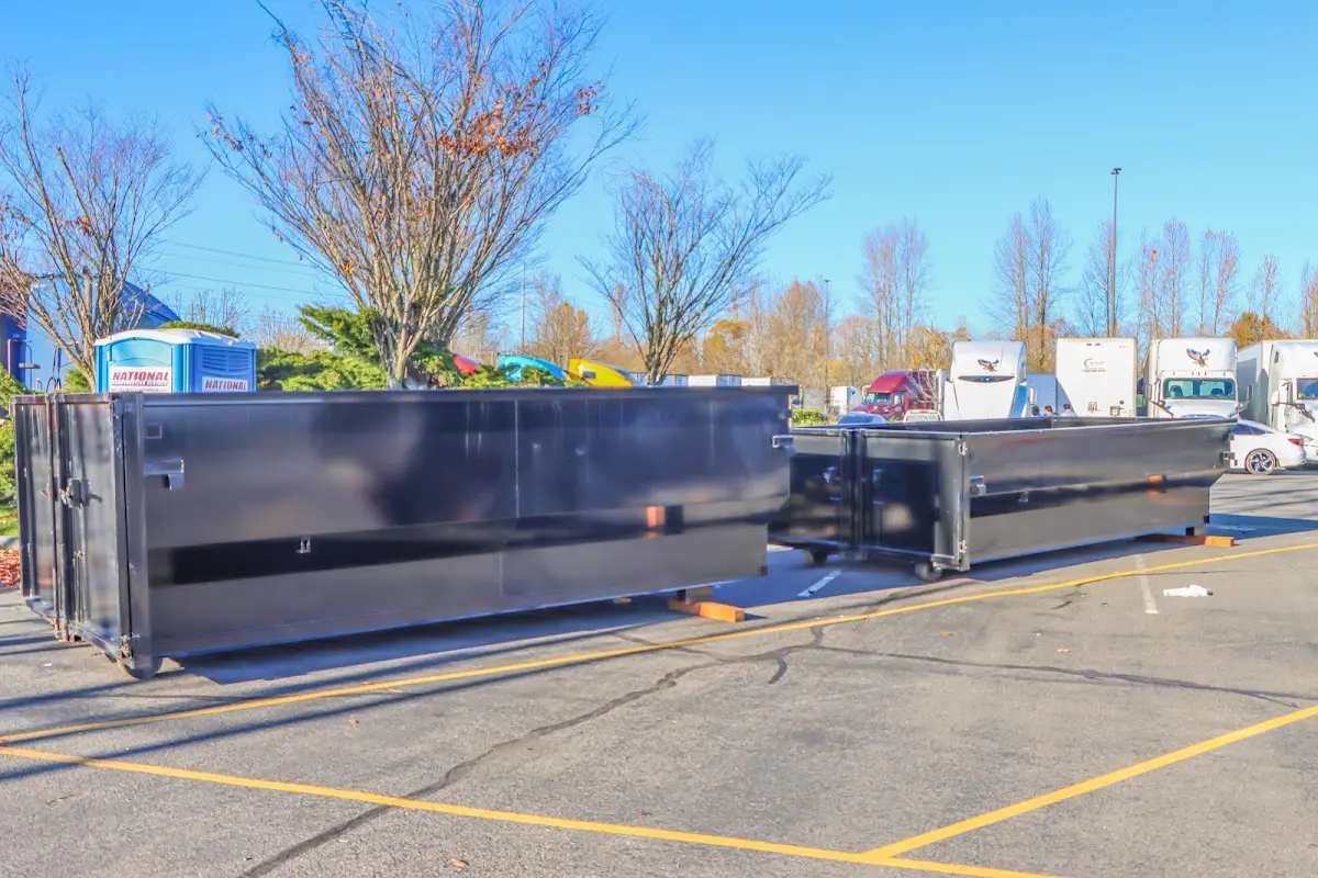 Professional dumpster rental service with roll-off container on residential driveway in Janesville